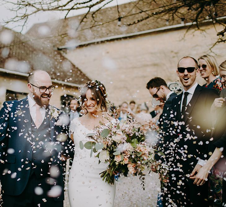 Confetti Moment with Bride in Pronovias Dralan Wedding Dress  and Groom in Navy Blue Moss Bros.  Suit