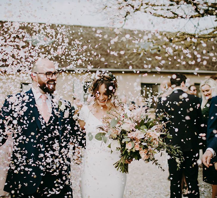 Confetti Exit with Bride in Pronovias Dralan Wedding Dress  and Groom in Navy Blue Moss Bros.  Suit