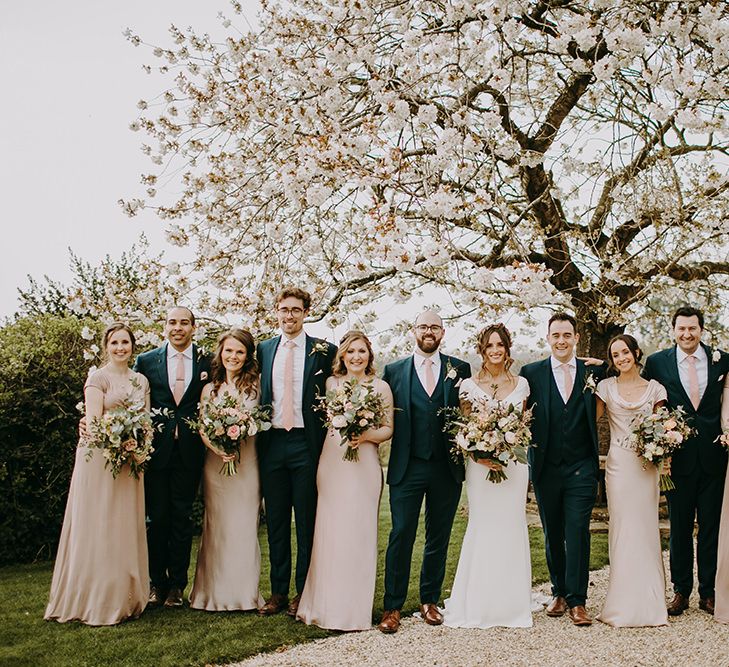 Wedding Party Portrait with Groomsmen in Navy Moss Bros. Suits, Bridesmaids in Pink Ghost Dresses and Bride in Pronovias Wedding Dress