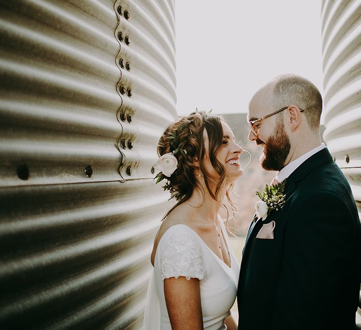 Bride in Pronovias Dralan Wedding Dress and Groom in Navy Moss Bros. Suit Smiling