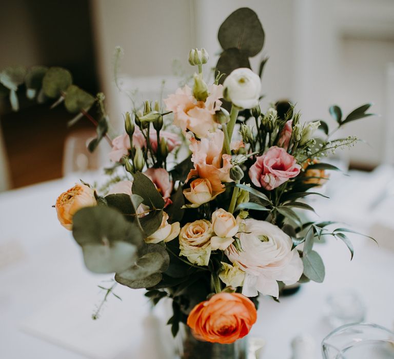 Wedding Floral Arrangements in Gin Bottles as Table Centrepieces