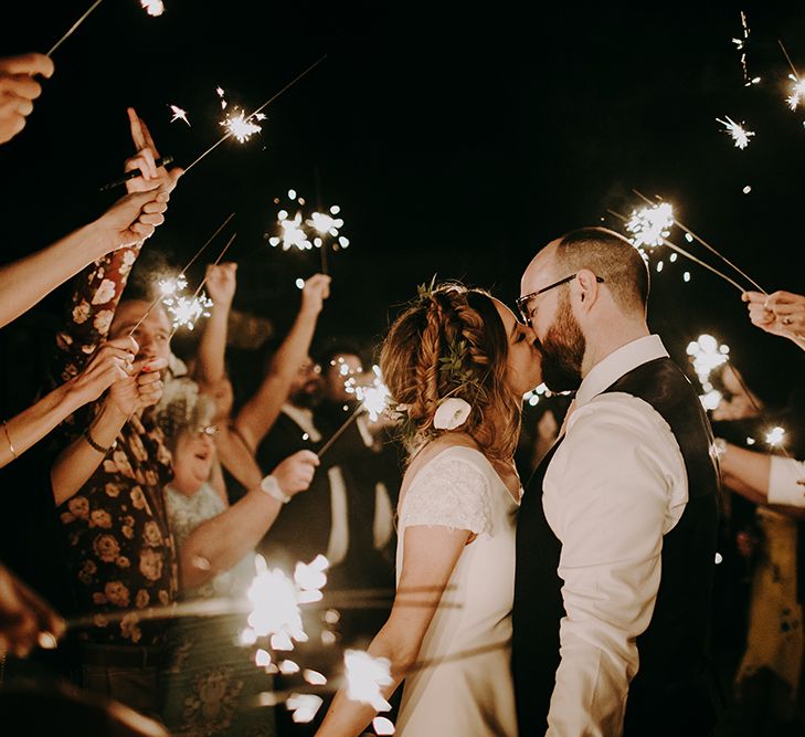 Sparkler Moment with Bride in Pronovias Dralan Wedding Dress and Groom in Moss Bros. Suit