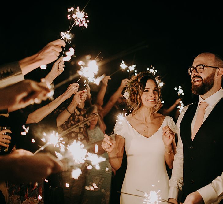 Sparkler Exit with Bride in Pronovias Dralan Wedding Dress and Groom in Moss Bros. Suit