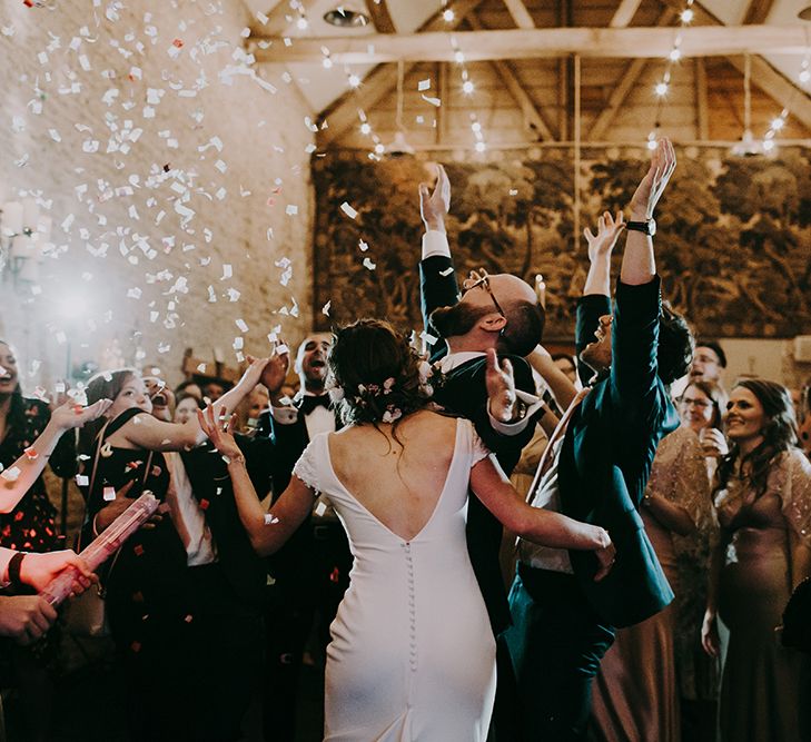 Confetti Bomb Dance Floor Moment  with Bride in Pronovias Dralan Wedding Dress and Groom in Moss Bros. Suit