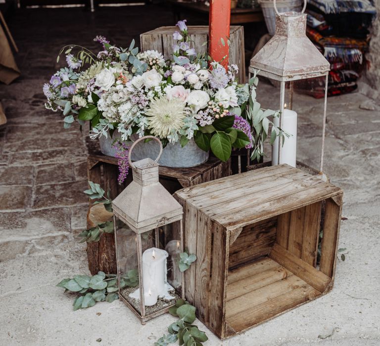 Candle lanterns and pastel floral arrangements at Cogges Manor Farm wedding