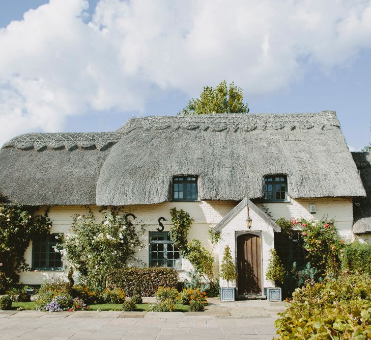 Pillar box cottage. British tweed countryside wedding complete with Vintage Fun Fair | Sandra Mansour Dress | Hunter Wellies | Marleybrook House | Hunter Wellies | Images by David Jenkins