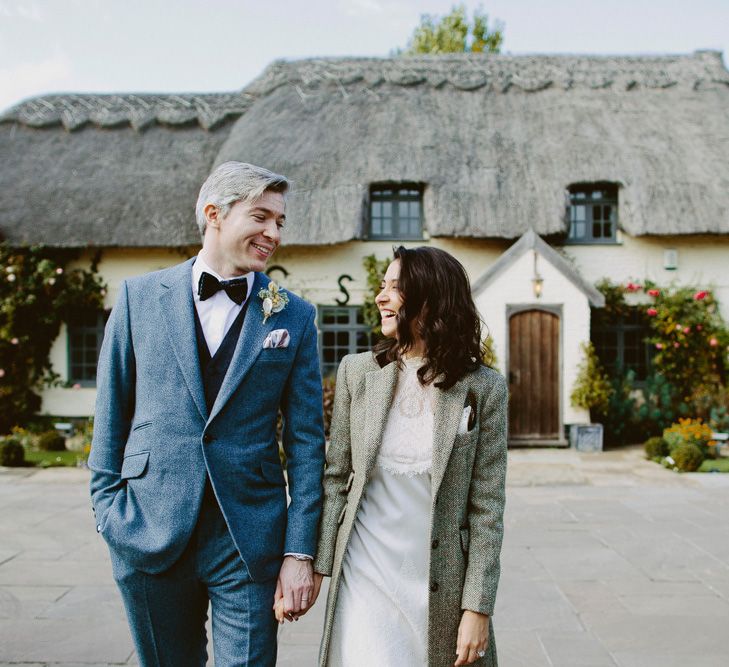 Bride wears tweed coat. British tweed countryside wedding complete with Vintage Fun Fair | Sandra Mansour Dress | Hunter Wellies | Marleybrook House | Hunter Wellies | Images by David Jenkins