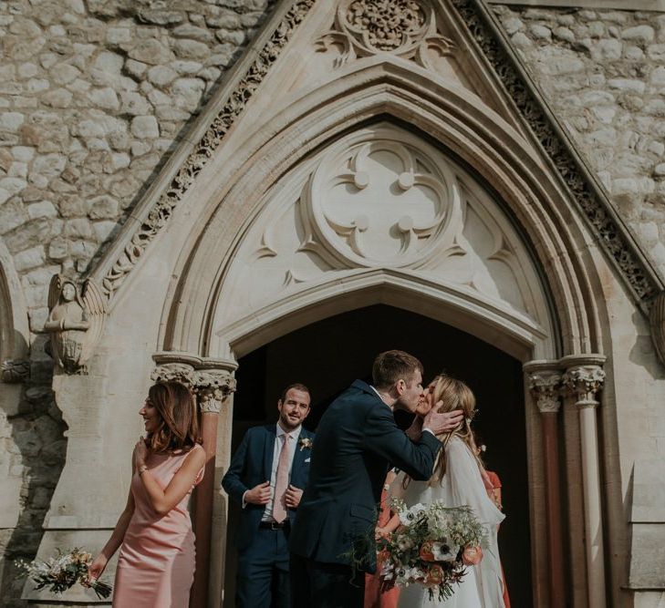 Bride And Groom Kiss Outside Church Ceremony Venue