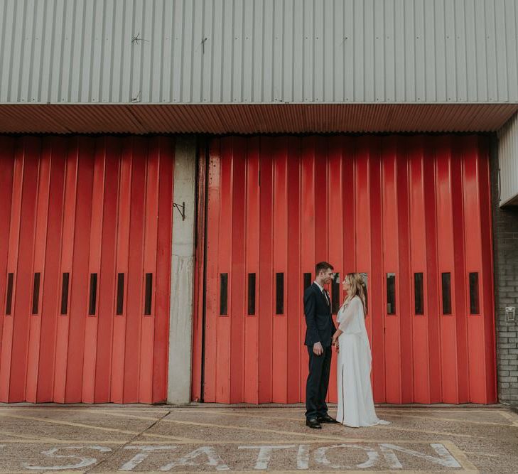 Bride In Wedding Cape With Husband