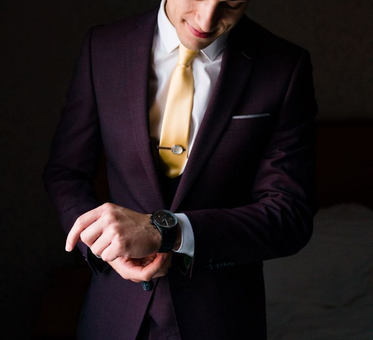 Groom in Burgundy Remus Uomo Suit