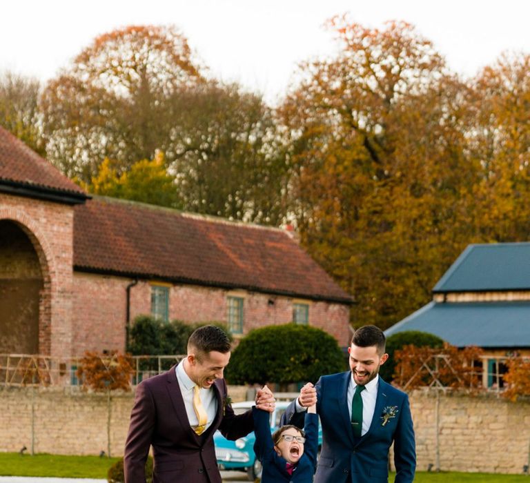 Grooms in Burgundy and Navy Remus Uomo Suits with Page Boy