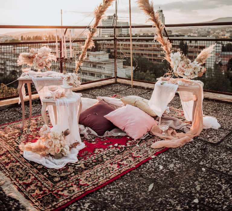 Intimate elopement on a rooftop with boho wedding decor