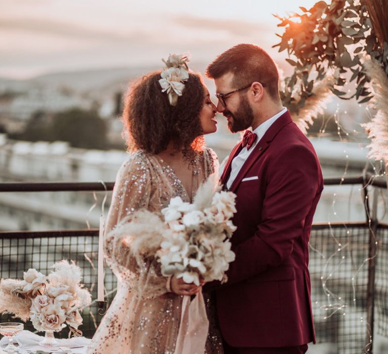 Stylish bride and groom at rooftop wedding ceremony