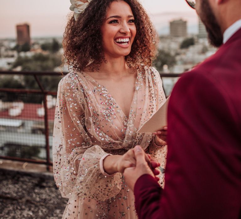 Bride in sparkle wedding dress with curly hair and flowers