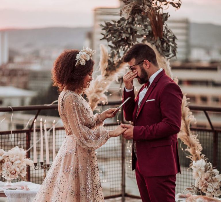 Emotional groom during intimate rooftop wedding ceremony