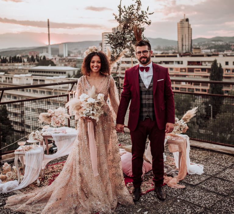 Boho bride and groom at rooftop wedding with sparkle wedding dress