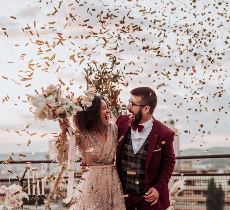 Confetti bomb moment at intimate rooftop wedding with bride in sparkle wedding dress