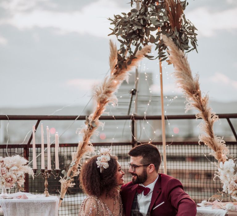 Boho picnic on the roof with rugs, cushions and naked tipi backdrop