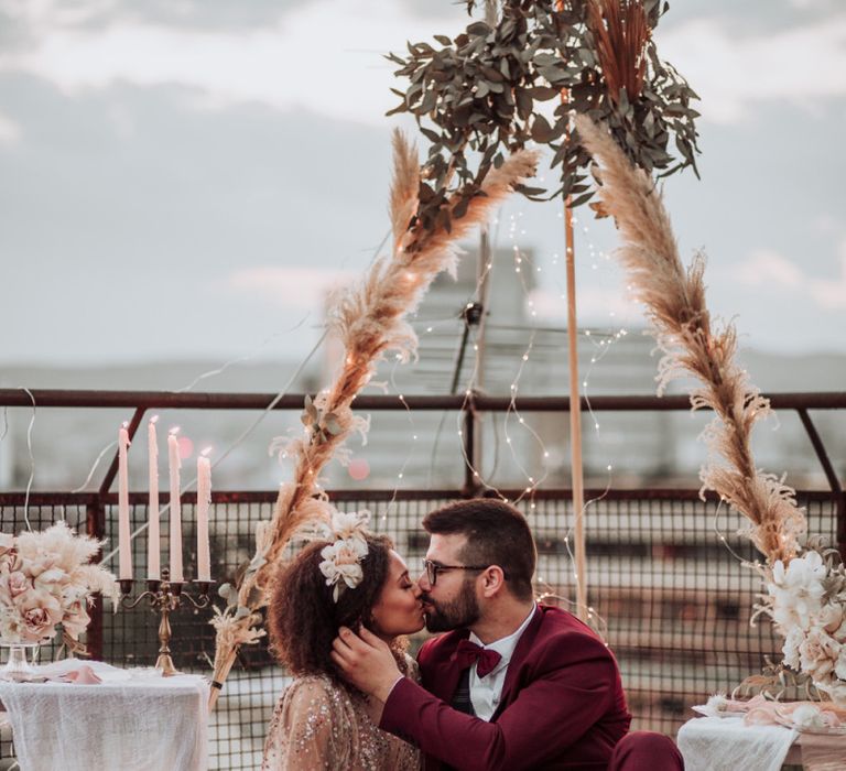 Intimate rooftop wedding with naked tipi, rugs, candles and fairy lights decor