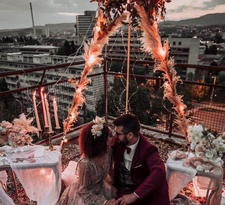 Intimate rooftop wedding with naked tipi covered in fairy lights