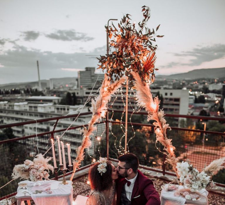 Bride in sparkle wedding dress kissing her groom