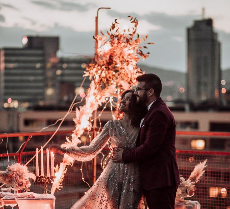 Boho bride in tulle and sparkle wedding dress at rooftop wedding reception