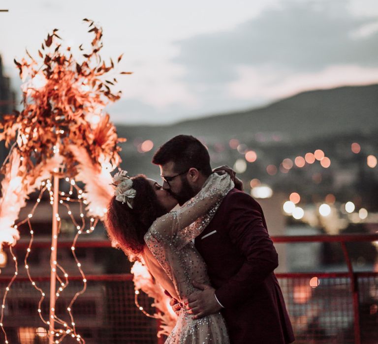 intimate rooftop wedding with bride in sparkle wedding dress glistening  under the fairy lights