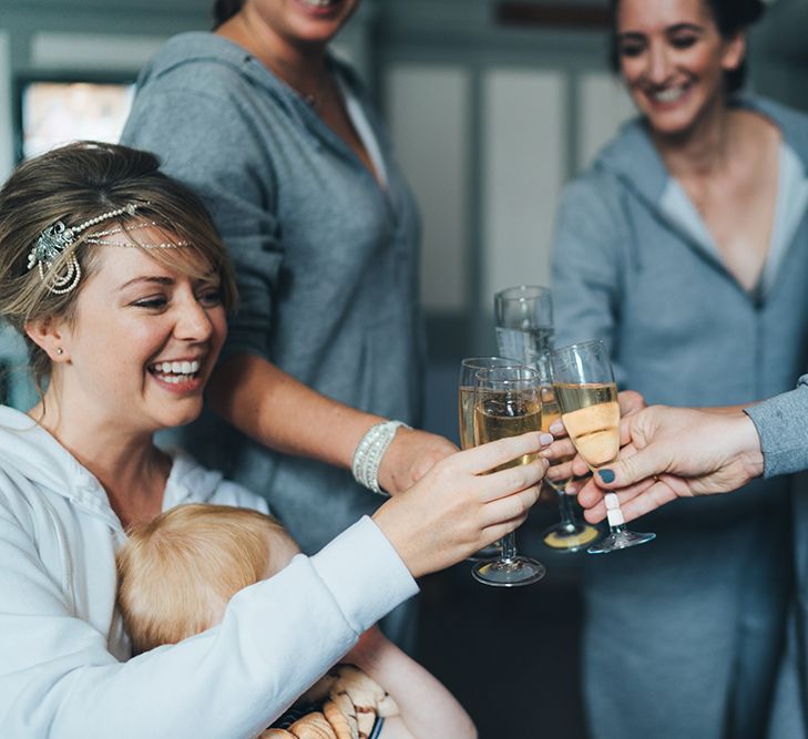 1920s Style Pearl Draping Headpiece | Bridesmaids in Grey Getting Ready Jumpsuits | Wedding Morning Champagne | Metallic Confetti Cannons and Paper Lanterns with Bride in Beaded Shoulder Eliza Jane Howell Dress | Miss Gen Photography