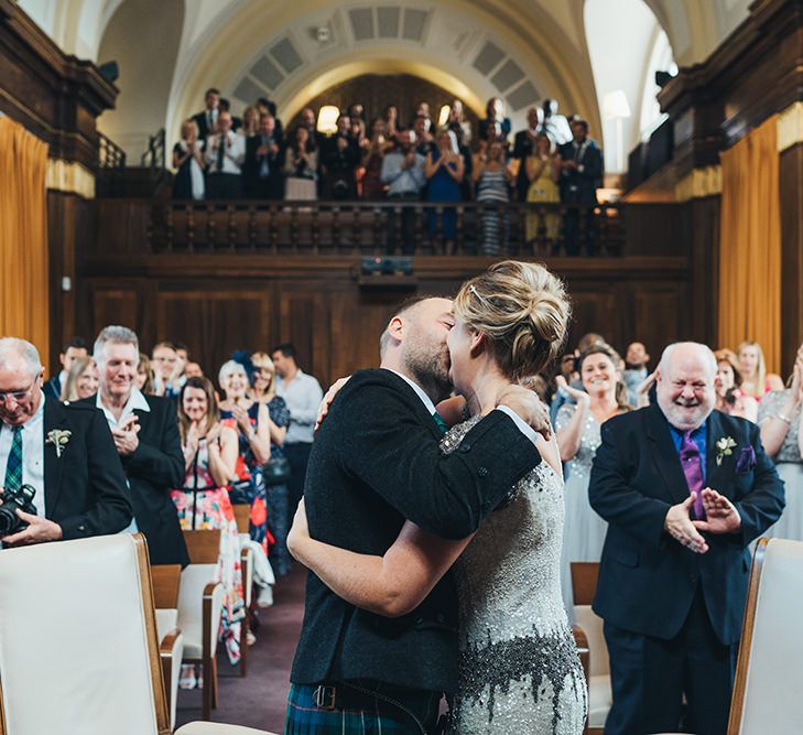 Bride in Embellished Shoulder Sequin Dress with Drop Waist by Eliza Jane Howell | Groom in Green and Blue Kilt | Wedding Ceremony at Stoke Newington Town Hall | Metallic Confetti Cannons and Paper Lanterns with Bride in Beaded Shoulder Eliza Jane Howell Dress | Miss Gen Photography