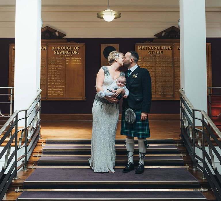 Bride in Embellished Shoulder Sequin Dress with Drop Waist by Eliza Jane Howell | 1920s Style Pearl Draping Headpiece | Groom in Green and Blue Kilt | Page boy in Kilt | Wedding Ceremony at Stoke Newington Town Hall | Metallic Confetti Cannons and Paper Lanterns with Bride in Beaded Shoulder Eliza Jane Howell Dress | Miss Gen Photography