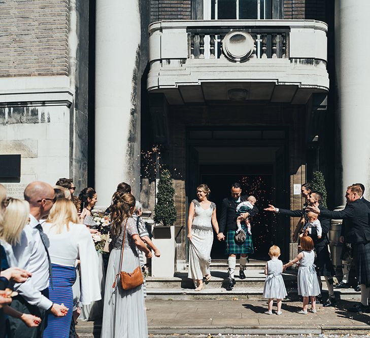 Bride in Embellished Shoulder Sequin Dress with Drop Waist by Eliza Jane Howell | Groom in Green and Blue Kilt | Page Boy in Kilt | Wedding Ceremony at Stoke Newington Town Hall | Metallic Confetti Cannons and Paper Lanterns with Bride in Beaded Shoulder Eliza Jane Howell Dress | Miss Gen Photography