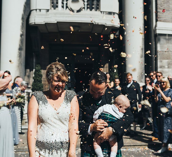 Bride in Embellished Shoulder Sequin Dress with Drop Waist by Eliza Jane Howell | 1920s Style Pearl Draping Headpiece | Groom in Green and Blue Kilt | Page Boy in Kilt | Wedding Ceremony at Stoke Newington Town Hall | Metallic Confetti Cannons and Paper Lanterns with Bride in Beaded Shoulder Eliza Jane Howell Dress | Miss Gen Photography