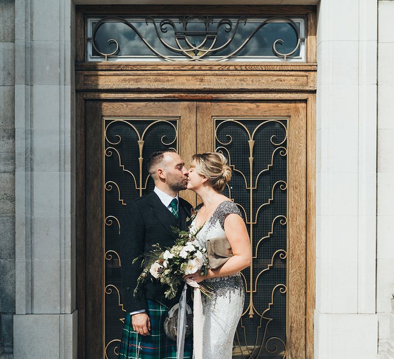 Bride in Embellished Shoulder Sequin Dress with Drop Waist by Eliza Jane Howell | 1920s Style Pearl Draping Headpiece | Bridal Bouquet with White Flowers, Foliage and Grey and Pink Trailing Ribbons | Groom in Green and Blue Tartan Kilt | Metallic Confetti Cannons and Paper Lanterns with Bride in Beaded Shoulder Eliza Jane Howell Dress | Miss Gen Photography