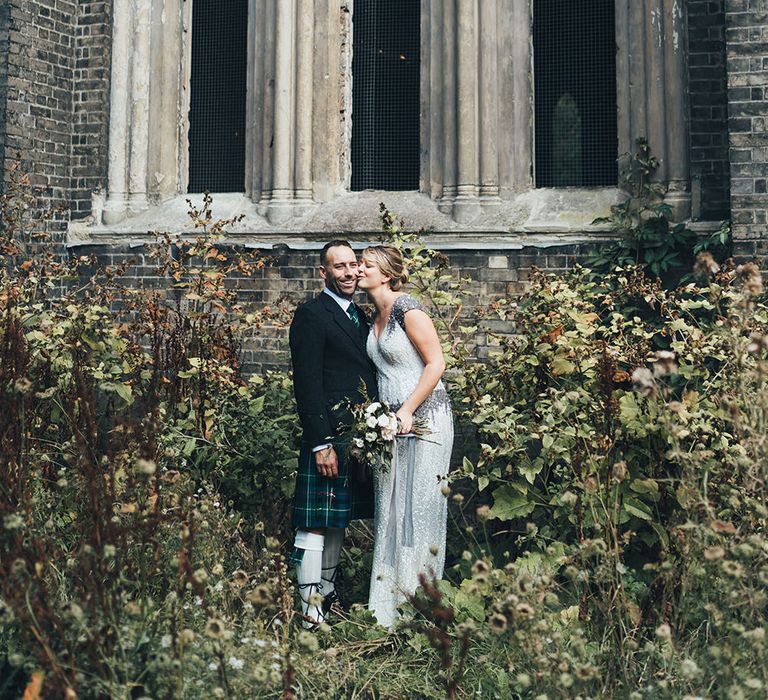 Bride in Embellished Shoulder Sequin Dress with Drop Waist by Eliza Jane Howell | 1920s Style Pearl Draping Headpiece | Bridal Bouquet with White Flowers, Foliage and Grey and Pink Trailing Ribbons | Groom in Green and Blue Tartan Kilt | Metallic Confetti Cannons and Paper Lanterns with Bride in Beaded Shoulder Eliza Jane Howell Dress | Miss Gen Photography