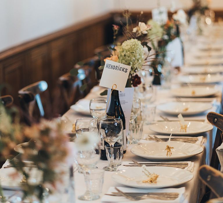 Banquet Tables | Wooden Chairs | Hendricks Gin Table Sign | Bud Vases | Gold Giraffe Place Settings | Wedding Reception at Clapton Country Club | Metallic Confetti Cannons and Paper Lanterns with Bride in Beaded Shoulder Eliza Jane Howell Dress | Miss Gen Photography