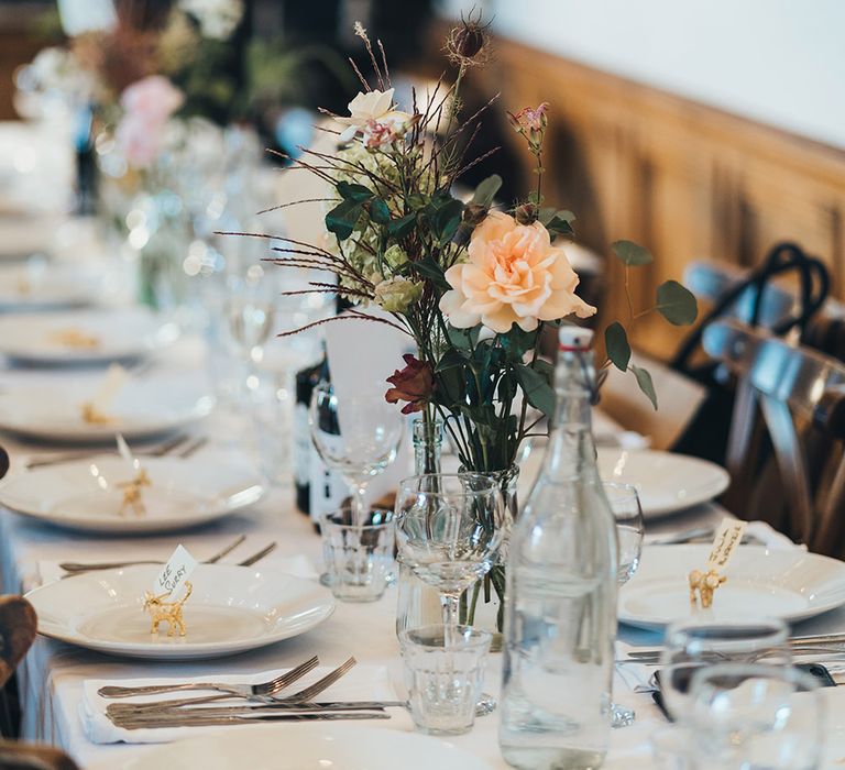 Bud Vase with Peach Flowers and Foliage | Gold Giraffe Place Settings | Wedding Reception at Clapton Country Club | Metallic Confetti Cannons and Paper Lanterns with Bride in Beaded Shoulder Eliza Jane Howell Dress | Miss Gen Photography