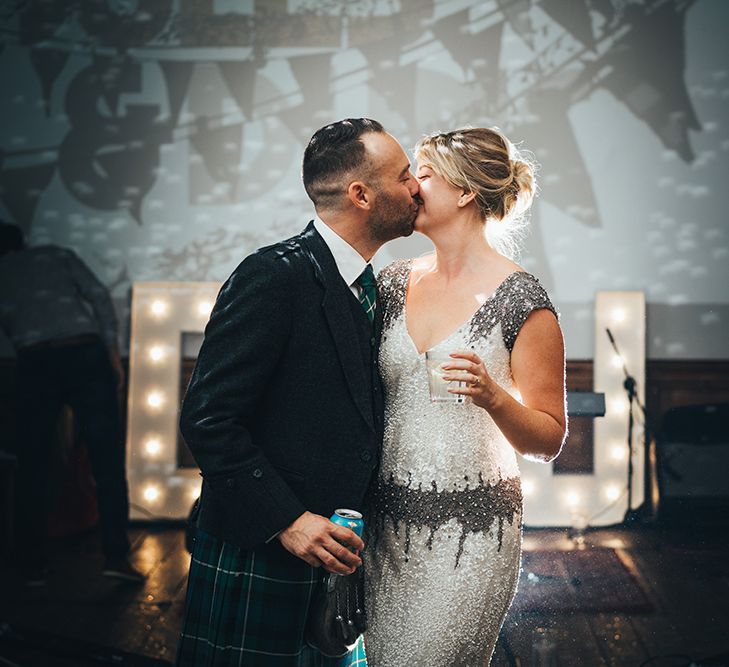 Bride in Embellished Shoulder Sequin Dress with Drop Waist by Eliza Jane Howell | 1920s Style Pearl Draping Headpiece | Groom in Green and Blue Tartan Kilt | Letter Lights | Clapton Country Club Wedding Reception | Metallic Confetti Cannons and Paper Lanterns with Bride in Beaded Shoulder Eliza Jane Howell Dress | Miss Gen Photography