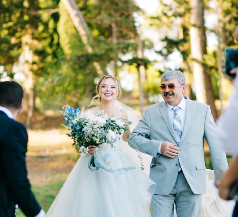 Outdoor Wedding Ceremony | Bridal Entrance in Coloured Hayley Paige Wedding Dress | Father of the Bride in Pale Blue Suit | Pastel Blue &amp; Green, Romantic, Destination Wedding at Corfu Luxury Villas, Planned by Rosmarin Weddings &amp; Events | Mikhail Balygin Fine Art Wedding Photographer