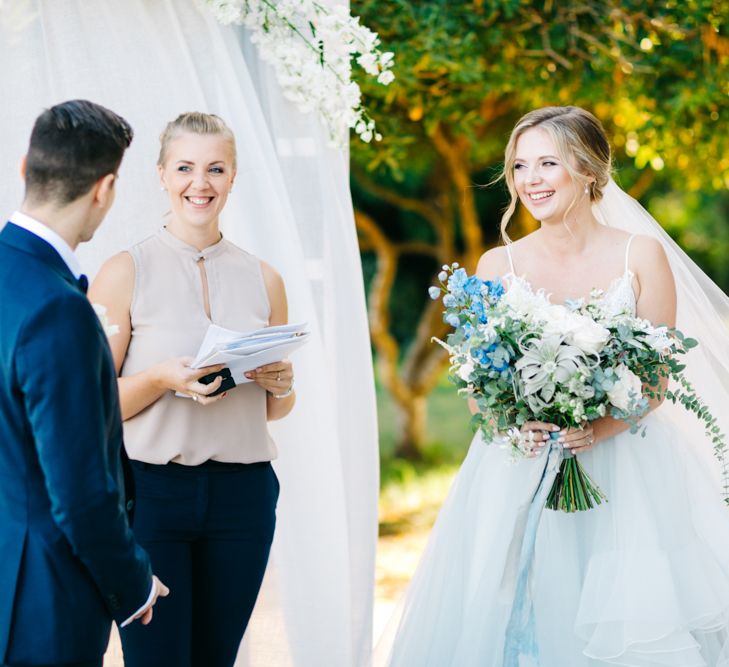 Outdoor Wedding Ceremony | Bride in Coloured Hayley Paige Wedding Dress | Oversized Bouquet | Groom in Navy Blue Tuxedo | Pastel Blue &amp; Green, Romantic, Destination Wedding at Corfu Luxury Villas, Planned by Rosmarin Weddings &amp; Events | Mikhail Balygin Fine Art Wedding Photographer