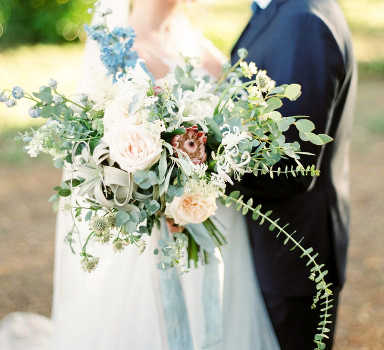 Oversized Bridal Bouquet | Bride in Coloured Hayley Paige Wedding Dress | Groom in Black Tie Suit | Pastel Blue &amp; Green, Romantic, Destination Wedding at Corfu Luxury Villas, Planned by Rosmarin Weddings &amp; Events | Mikhail Balygin Fine Art Wedding Photographer