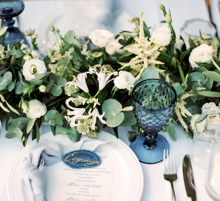 Elegant Place Setting with Coloured Goblet, Floral Table Runner, Taper Candles &amp; Geode Name Place | Pastel Blue &amp; Green, Romantic, Destination Wedding at Corfu Luxury Villas, Planned by Rosmarin Weddings &amp; Events | Mikhail Balygin Fine Art Wedding Photographer