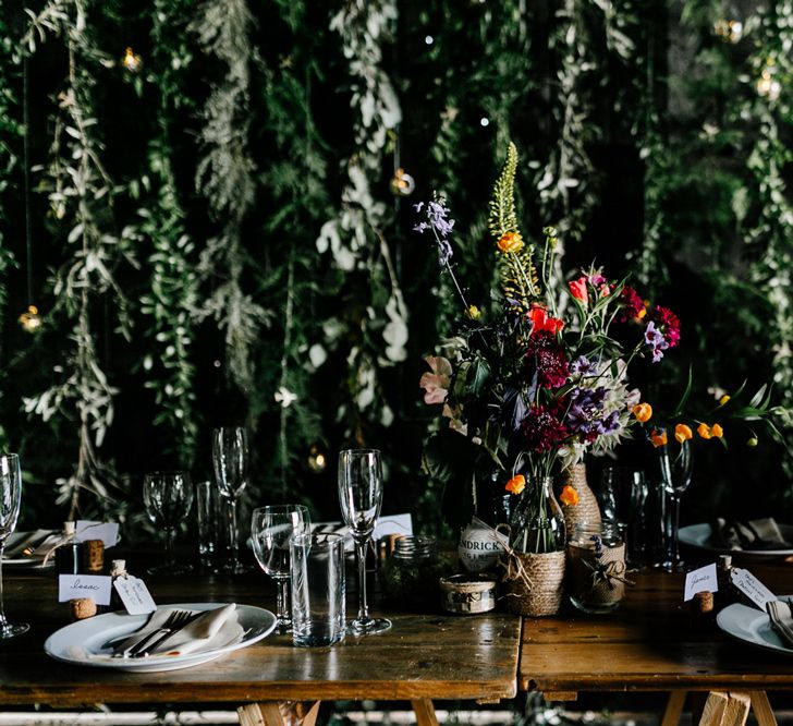 Rustic Table Centrepieces of Flower Stems in Bottles wrapped in Twine