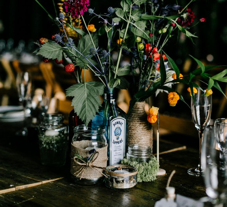 Colourful Wild Flowers Centrepiece in Gin Bottles