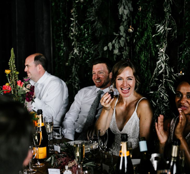 Bride in Made with Love Lace Wedding Dress and Groom in  Godfather Tailoring During Reception Speeches