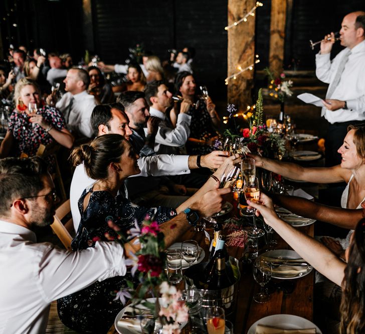 Wedding Guest Cheers at Barn Wedding Reception