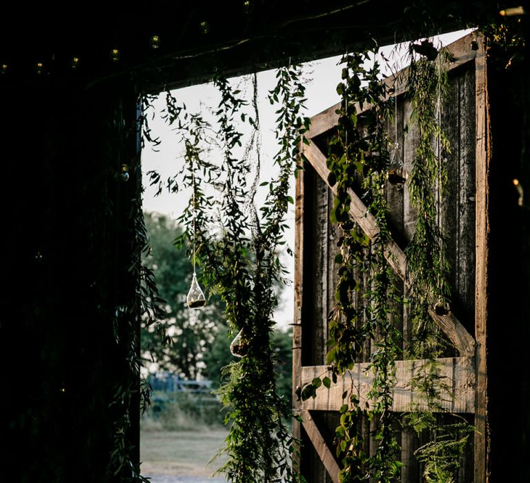 Barn Door Covered in Hanging Green Foliage