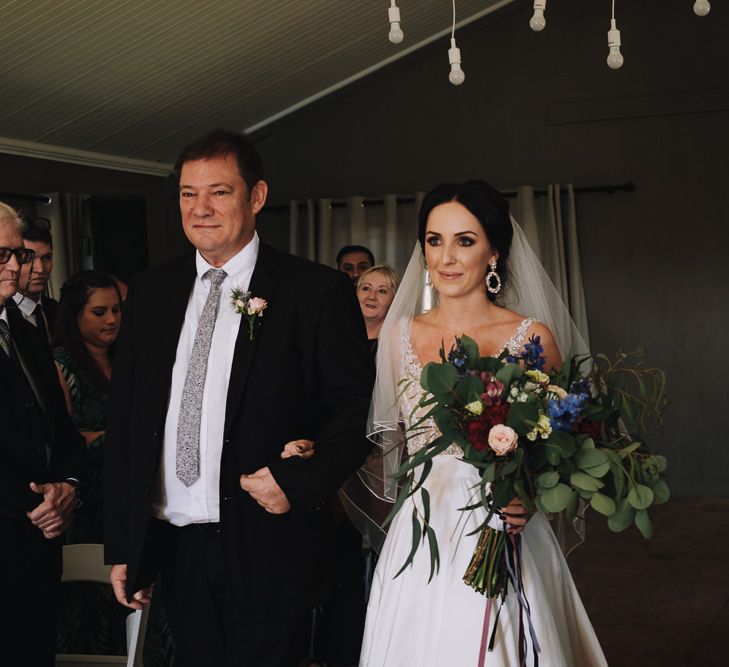 Father Of The Bride Walks Daughter Up The Aisle While She Holds Beautiful  Bouquet