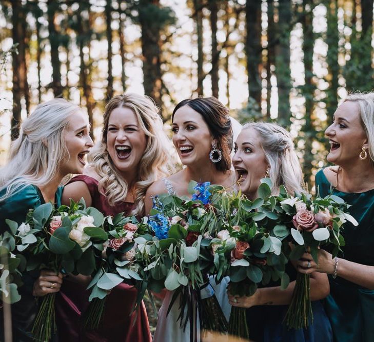 Bridal Party In Different Coloured Bridesmaid Dresses With Bouquets