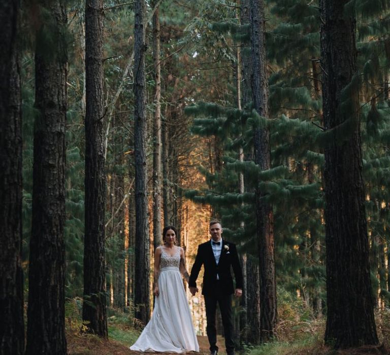 Bride and Groom Walk Through Forest In South Africa