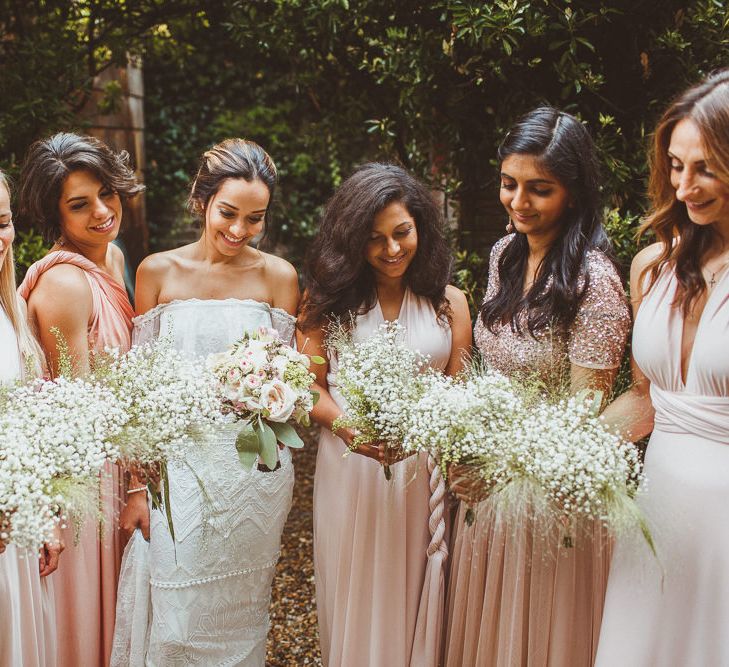 Bridal Party Portrait with Bride in Grace Loves Lace Wedding Dress and Bridesmaids in Different Blush Dresses